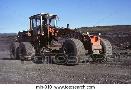 Stock Image - Tractor With Dozer Blade Trimsaran Coal Mine Wales. Fotosearch