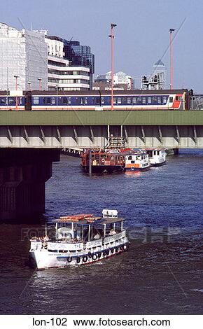 Train on Bridge Passing Boat London England View Large Photo Image Stock Image - Train on Bridge Passing Boat London England. Fotosearch