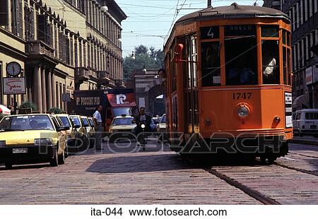 Picture - Tram, Car and Moped in Street Milan Italy Europe. Fotosearch