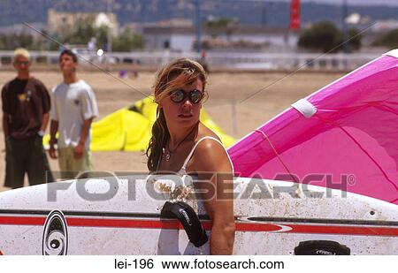 Stock Photograph - Woman Carrying Windsurfing Board. Fotosearch