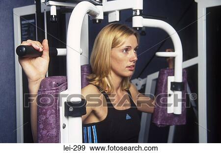 Stock Photo - Woman on Exercise Machine UK. Fotosearch