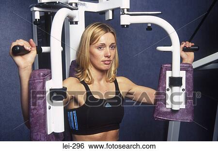 Stock Photograph - Woman on Exercise Machine UK. Fotosearch