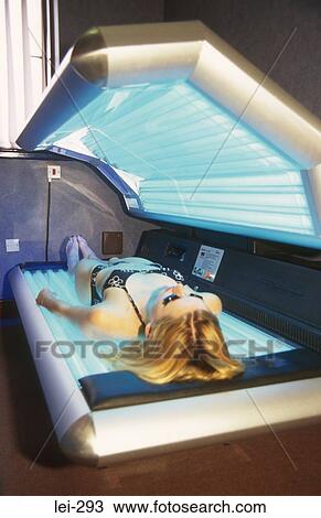 Stock Image - Woman on Sunbed UK. Fotosearch