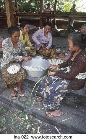 Stock Image - Women Making Offerings at Petitenget Temple Seminyak Bali. Fotosearch