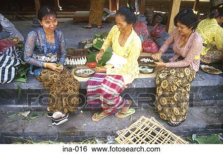 Stock Photograph - Women Making Offerings at Petitenget Temple Seminyak Bali. Fotosearch
