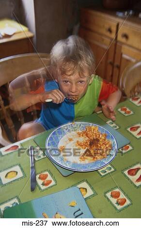 Stock Photo - Young Boy Eating Baked Beans UK. Fotosearch