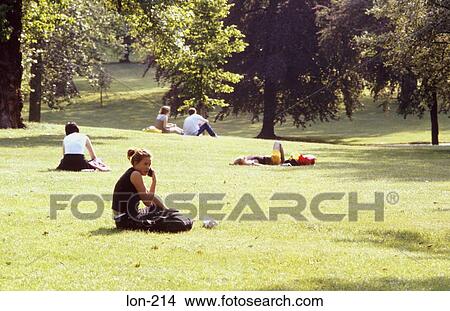 Young Woman Using Mobile Phone in London Park UK View Large Photo Image Picture - Young Woman Using Mobile Phone in London Park UK. Fotosearch