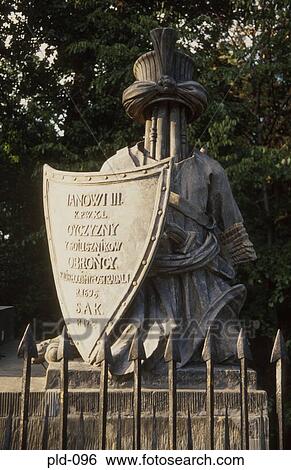 Stock Photograph - Abstract Statue of Figure with Shield Warsaw Poland. Fotosearch