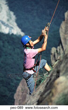 Asian Man Climbing Rockface Korea View Large Photo Image Stock Photo - Asian Man Climbing Rockface Korea. Fotosearch