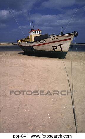 Stock Image - Boat on Shoreline Portugal Europe. Fotosearch