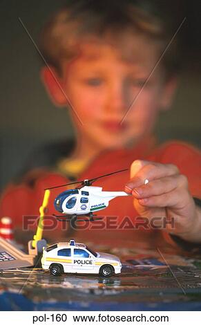 Boy Playing with Model Police Vehicles View Large Photo Image Stock Image - Boy Playing with Model Police Vehicles. Fotosearch
