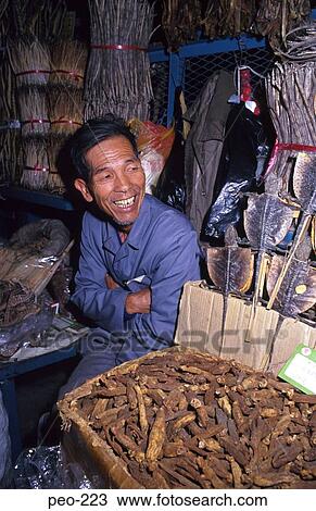 Stock Image - Chinese Man at Dried Food Stall Canton China. Fotosearch