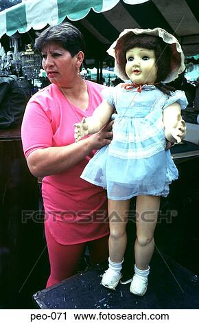 Colombian Market Trader Holding a Large Doll View Large Photo Image Stock Image - Colombian Market Trader Holding a Large Doll. Fotosearch