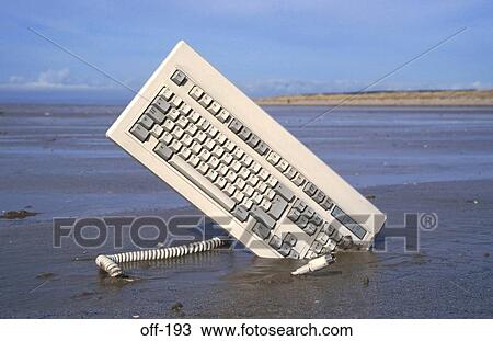 Stock Image - Computer Keyboard in Sandy Beach. Fotosearch