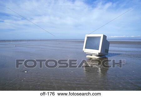 Stock Photograph - Computer Monitor on Empty Sand Beach. Fotosearch