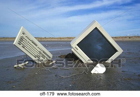 Stock Photo - Computer Part Buried in Sand. Fotosearch