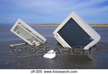 Stock Photography - Computer Part Buried in Sand. Fotosearch