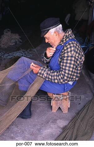 Fisherman Mending Nets Olhao Portugal View Large Photo Image Stock Photo - Fisherman Mending Nets Olhao Portugal. Fotosearch