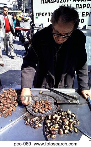 Stock Photo - Greek Man Roasting Chestnuts to Sell. Fotosearch