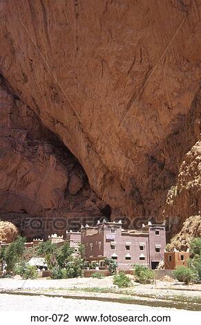 Stock Image - Hotel at Base of Enormous Cliff Todra Gorge Morocco. Fotosearch
