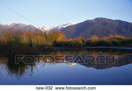 Stock Image - Lake Margin Plants and Mountains Beyond New Zealand. Fotosearch