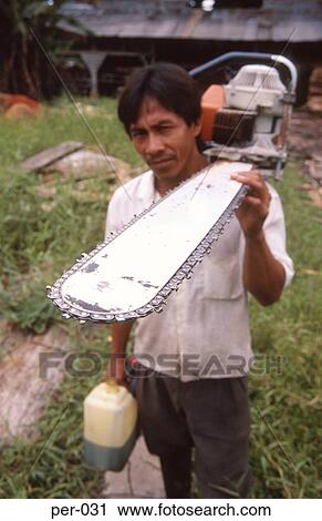 Stock Image - Logger Carrying Chainsaw Peru. Fotosearch