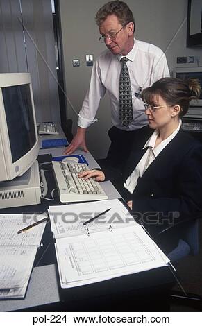 Man and Woman Looking at Computer Monitor UK View Large Photo Image Picture - Man and Woman Looking at Computer Monitor UK. Fotosearch