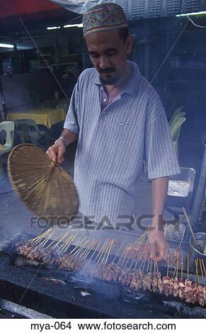 Picture - Man Cooking Skewered Meat Kuala Lumpur Malaysia. Fotosearch