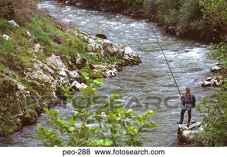 Stock Photo - Man Fly Fishing in Mountain Brook in Spain. Fotosearch