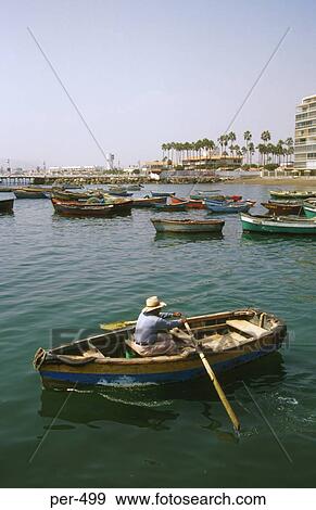 Stock Photo - Man in Rowing Boat Ancon Peru. Fotosearch