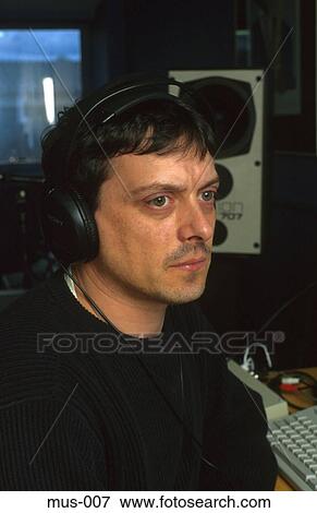 Man in Studio Wearing Headphones View Large Photo Image Stock Photo - Man in Studio Wearing Headphones. Fotosearch