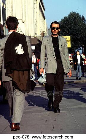 Stock Photo - Man Wearing Sunglasses Walking along London Street. Fotosearch