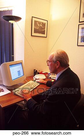 Stock Photograph - Middle Aged Businessman at Computer. Fotosearch