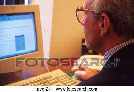 Middle Aged Man using Computer in Office View Large Photo Image Stock Image - Middle Aged Man using Computer in Office. Fotosearch