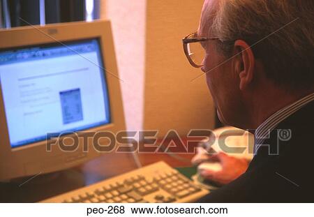 Middle Aged Man using Computer in Office View Large Photo Image Stock Photo - Middle Aged Man using Computer in Office. Fotosearch