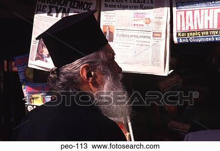 Stock Image - Old Greek Orthodox Priest at News Stand Greece. Fotosearch