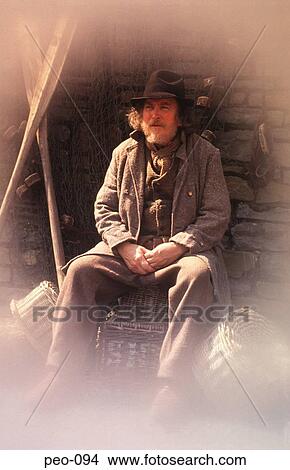 Picture - Old Man in Costume Sitting UK. Fotosearch
