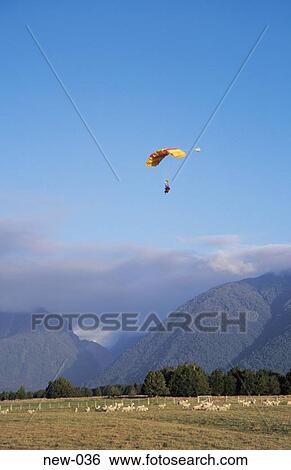 Stock Photograph - Paraglider near Mountains New Zealand. Fotosearch