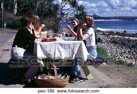 Stock Photography - People Eating Outside near an Australian Beach. Fotosearch