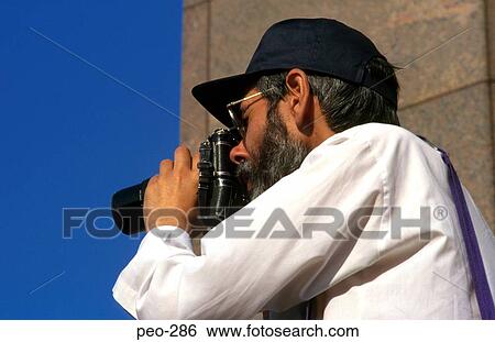 Stock Photograph - Photographer Using Telephoto Lensed Camera. Fotosearch