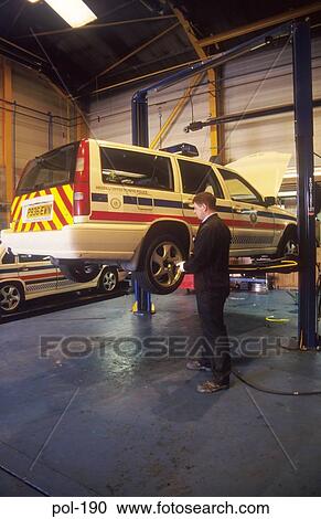 Police Patrol Car on Inspection Lift UK View Large Photo Image Stock Image - Police Patrol Car on Inspection Lift UK. Fotosearch