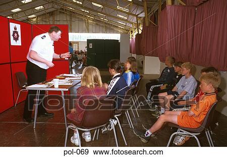 Stock Photo - Policeman Talking to Children on Safety Day. Fotosearch
