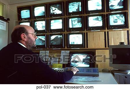 Stock Photo - Policeman Viewing Security Camera Screens. Fotosearch
