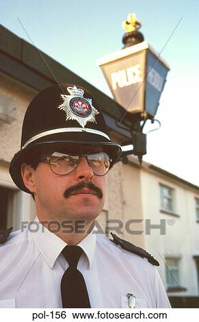 Policeman with Helmet outside Station Dyfed UK View Large Photo Image Stock Photograph - Policeman with Helmet outside Station Dyfed UK. Fotosearch