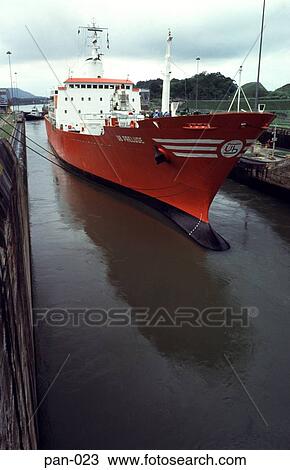 Stock Image - Red Transport Ship in Panama Canal. Fotosearch