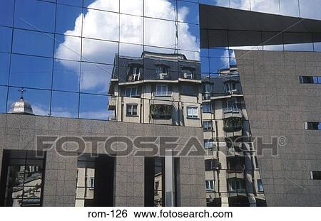 Stock Photograph - Reflections in a Glass Office Block Bucharest Romania. Fotosearch