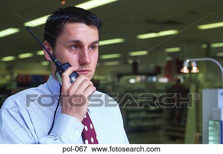 Store Detective Using Radio Handset in Shop View Large Photo Image Stock Photo - Store Detective Using Radio Handset in Shop. Fotosearch