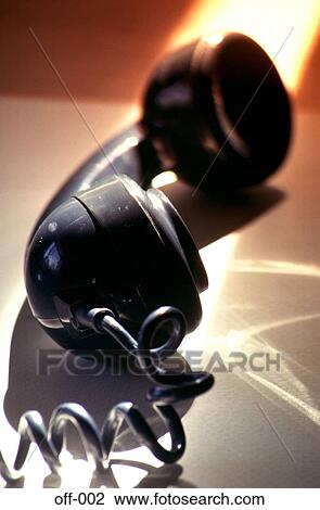 Stock Image - Telephone Handset on Desk in Tinted Light. Fotosearch