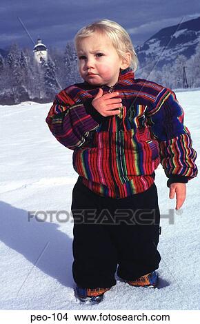 Picture - Toddler Standing in the Snow Austria. Fotosearch