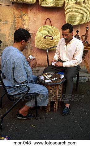 Two Men Playing Cards on Pavement Morocco View Large Photo Image Stock Photo - Two Men Playing Cards on Pavement Morocco. Fotosearch